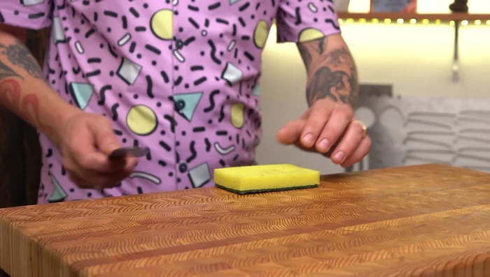 Wipe the blade with a wet, soapy sponge.