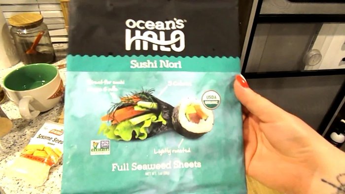Prepare ingredients: sushi nori, filling (spicy tuna, avocado, cucumber, carrot, green onions), sushi rice (mixed with sesame oil), spicy mayo (or sriracha).