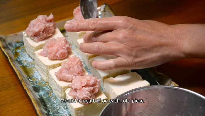 Place a meatball on top of each tofu piece.