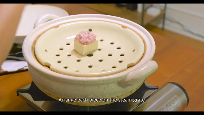 Arrange the meat and tofu pieces on the steam grate of the pre-heated donut steamer. Cover and steam over medium-high heat for 7-8 minutes, or until the pork is cooked through.