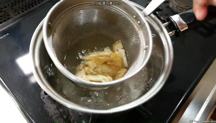 Parboil the fried tofu in boiling water.