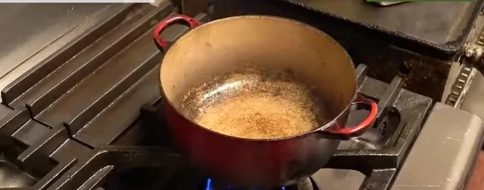 Return some of the rendered duck fat to the pot. Add garlic and bacon for additional flavor.