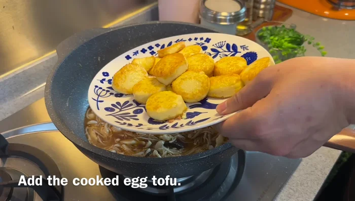 Gently add the pan-fried egg tofu to the sauce.