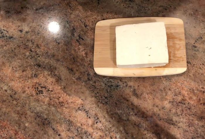 Let the tofu cool slightly, then cut it into thin slices (2-3 mm thick).
