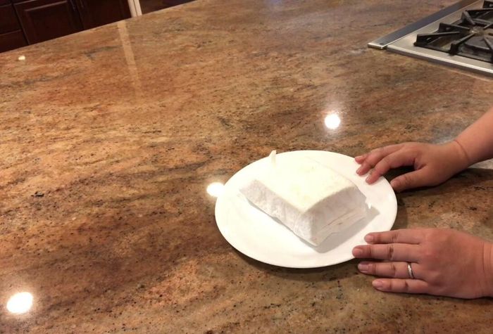 Microwave the tofu for 3 minutes. Alternatively, you can press it overnight in the fridge under a weight.