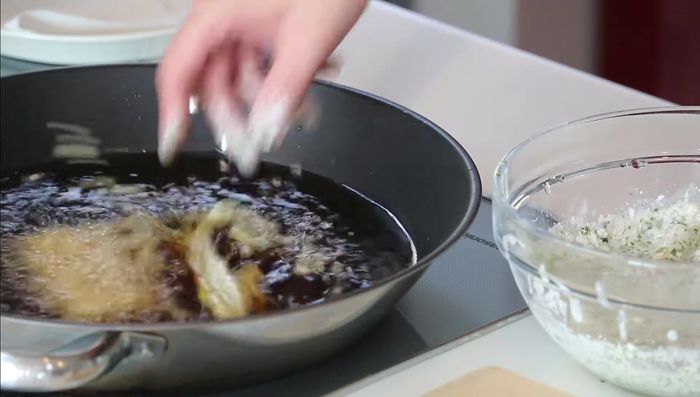 Carefully place the battered chikuwa into the hot oil and fry for approximately 1 minute per side, until golden brown and crispy.