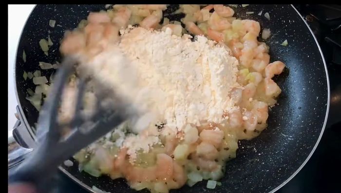 Stir in shrimp, corn, garlic, and black pepper.