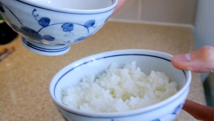 Serve on top of a bowl of hot steamed rice. Season with soy sauce.