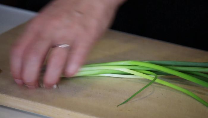Finely chop green onions.