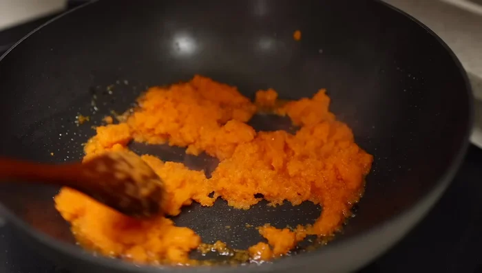 Add the vegetable puree to the wok/pot and cook for 2-3 minutes, or until most of the liquid has evaporated, stirring constantly to prevent burning.