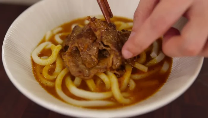 Serve the noodles in a bowl, top with the curry broth and beef. Add a soft-boiled egg and green onions (optional).