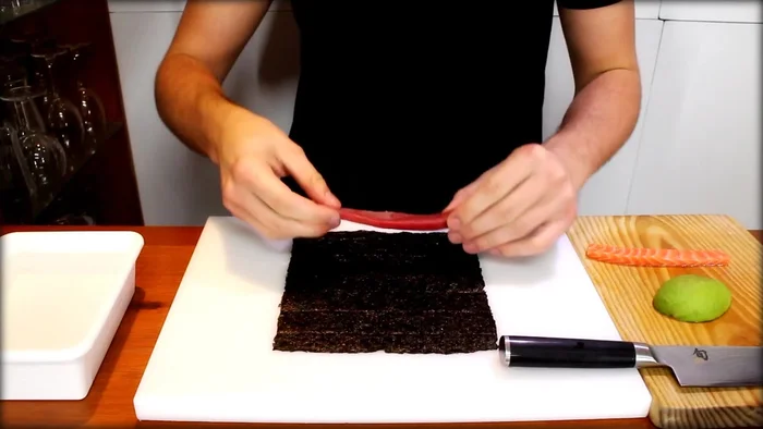 Place sushi-grade tuna on the nori. Make a square shape.