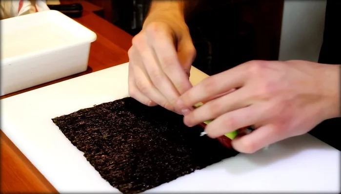 Arrange the avocado squares on top of the salmon and rice.