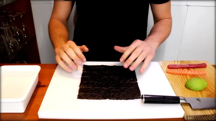 Lay down a whole nori sheet.