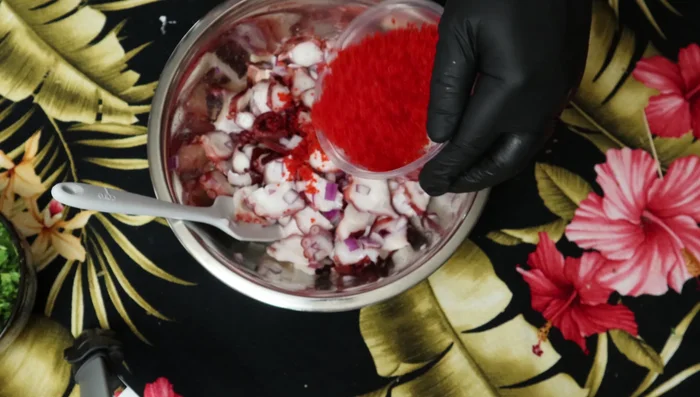 Incorporate red tobiko into the mixture, ensuring even distribution.