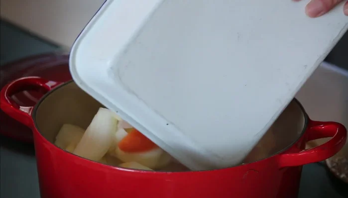 Add the prepared vegetables to the pot and cook until they are lightly coated with oil (238.08).