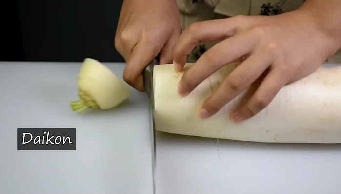 Prepare garnishes: Finely chop spring onions and grate a small piece of daikon radish. (106.399)