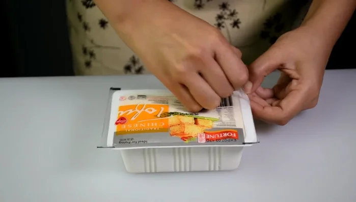 Prepare the tofu: Wrap the tofu in several layers of paper towels to absorb excess water. Let it sit for about 20 minutes. (49.05)