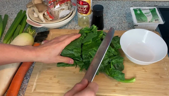 Cut all ingredients into bite-sized pieces. Start with the chicken, daikon radish (use the bottom, slightly tangier part), carrots, tofu, and mushrooms.
