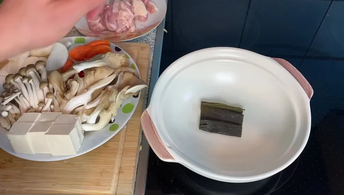 Prepare the broth: In a pot, add a strip of kombu kelp and hot water. Bring to a boil, then remove the kombu.
