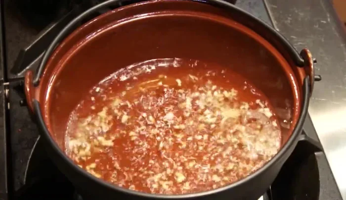 Add clams to the boiling broth, lower the heat, and cook for 2 minutes until they open. Discard any clams that don't open.