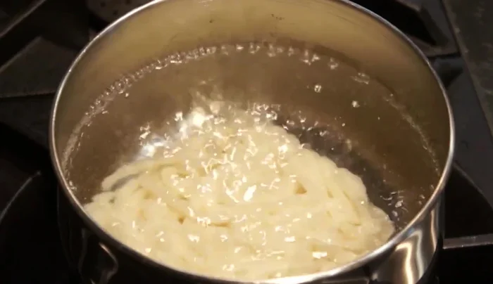 Prepare Udon noodles according to package directions.