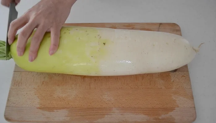 Choose a good daikon: straight, smooth, shiny skin, and heavy for its size. Scrub well and cut off the leaves. Use the center part for the most tender result.