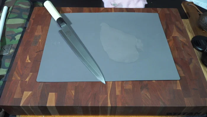 Sharp knife on cutting board, food prep