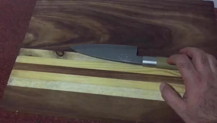 Single-edged knife on wooden cutting board