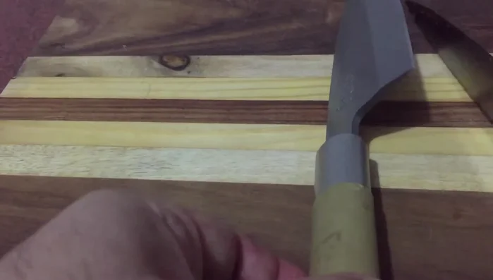 Single-edged knife on wooden board