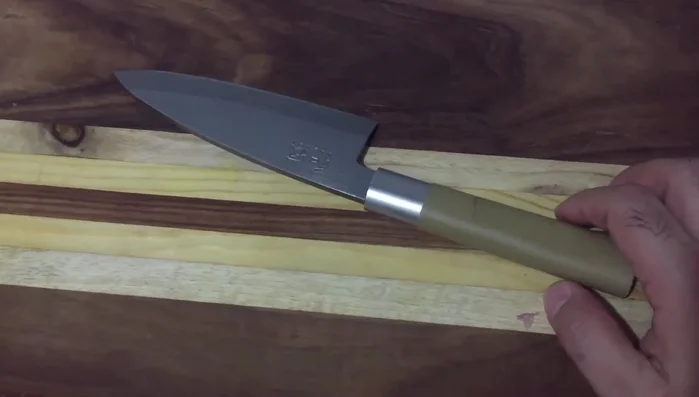 KAI Wasabi deba knife on wood board