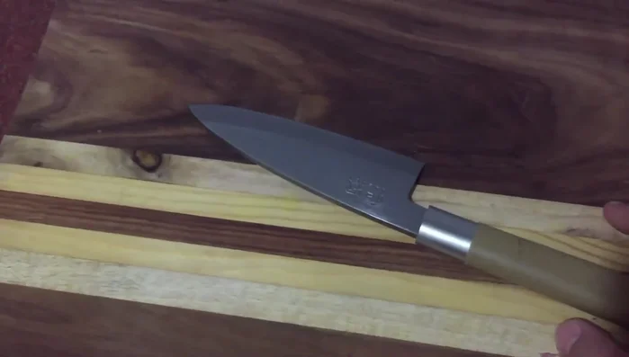 KAI Wasabi deba knife on cutting board