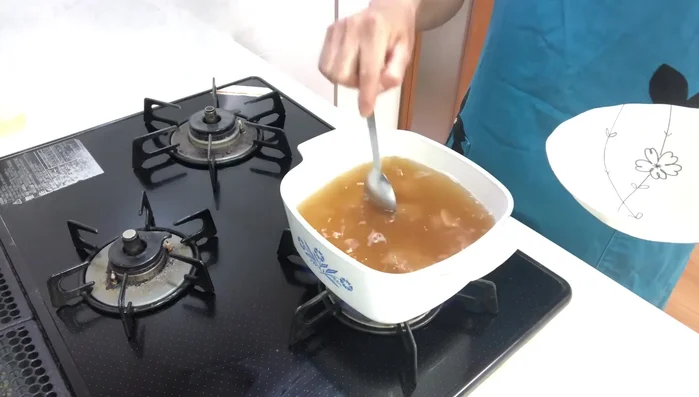 Add Ingredients: Add chicken, then burdock, maitake mushrooms, and finally, kiritampo and white spring onion. Simmer for about 5 minutes.
