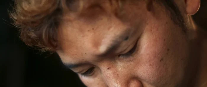 Close-up of Ishida, contemplating Bizen ware.