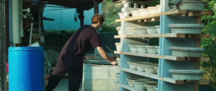 Artist working with pottery in studio