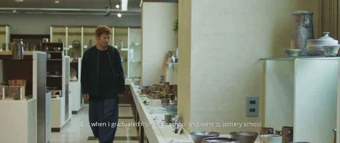Man walking through pottery shop