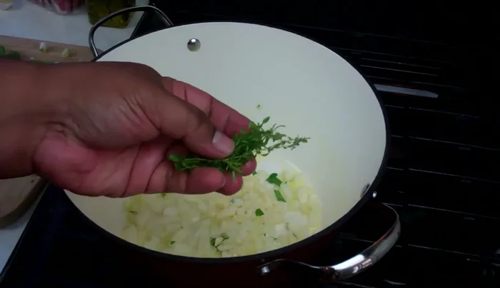 Add fresh thyme, Chinese celery, and scallions. Cook gently for 3-4 minutes to build flavor.