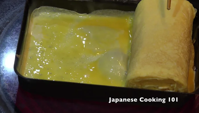 Use chopsticks or a spatula to help shape the tamagoyaki and ensure even cooking. Lightly press to shape.