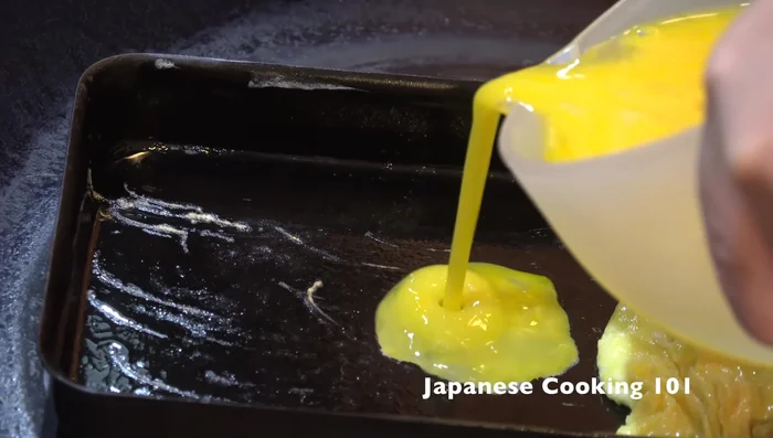 Pour another thin layer of egg mixture, let it set, and roll it over the existing layer.