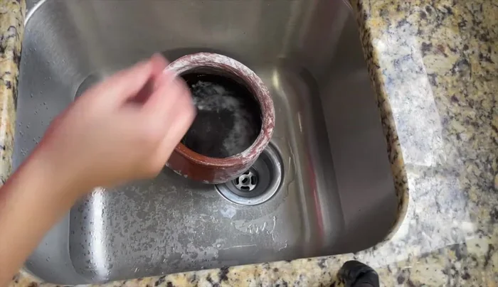 Wash thoroughly: Wash the pots under running water using a sponge or scrubber. Do not use soap. (203.84)