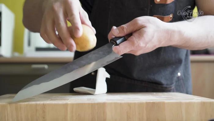Santoku knife cutting potato