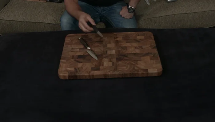 Wooden cutting board with knife