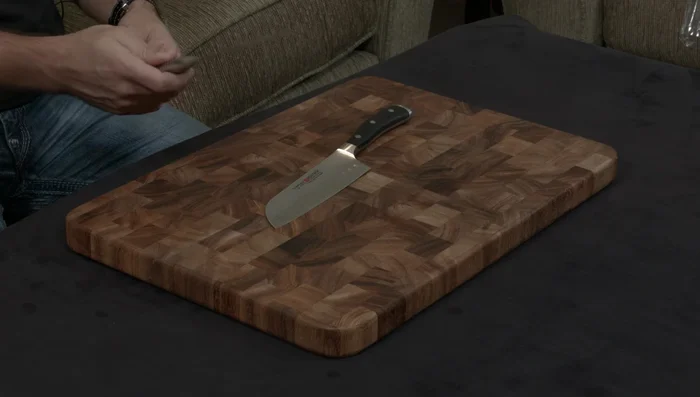 Wüsthof Ikon Santoku knife on wood board