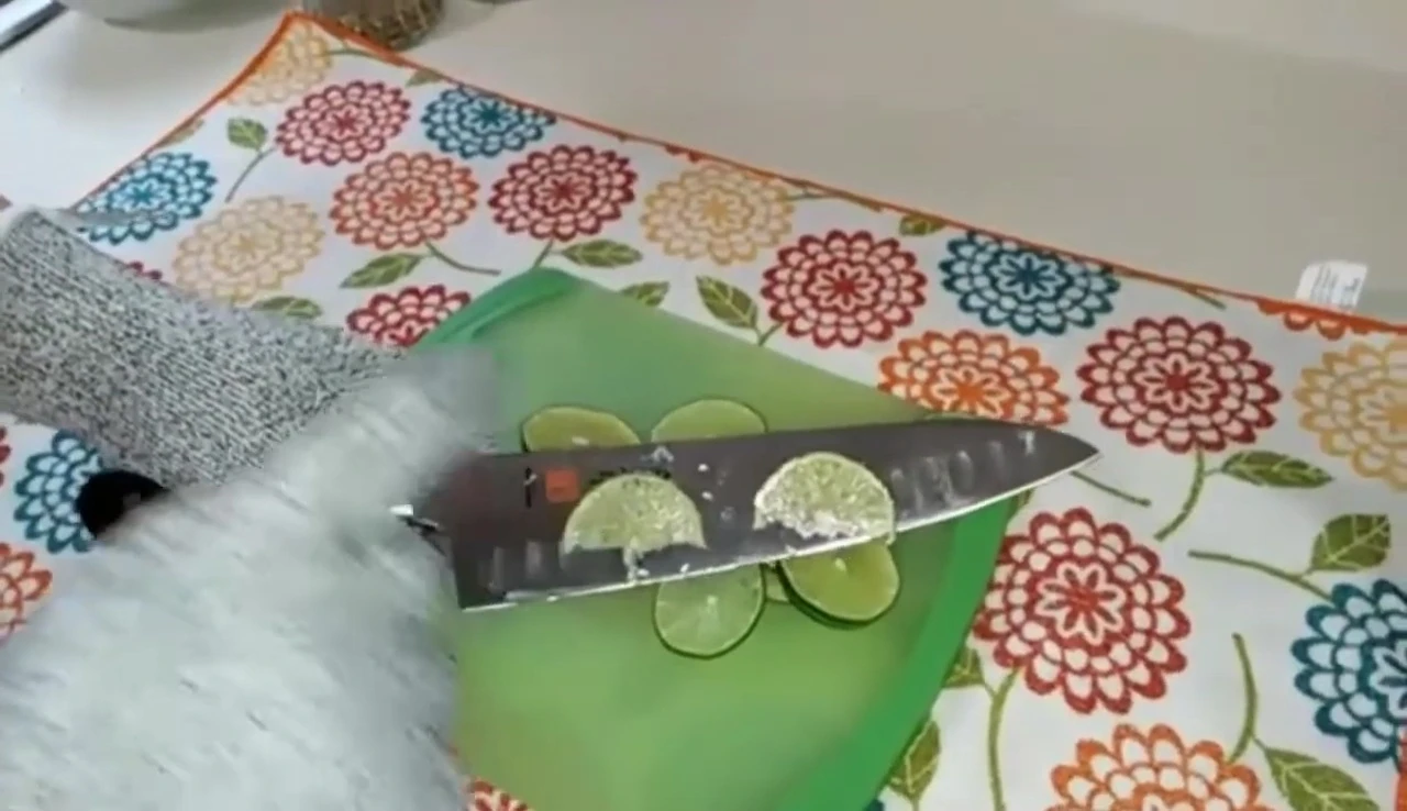 Knife cutting limes on board