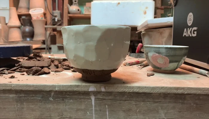 Unfired pottery bowls on workbench