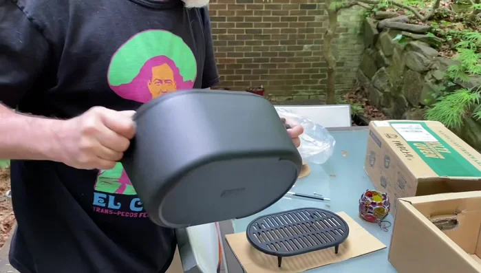 Griddle on Dutch oven lid: simultaneous cooking.