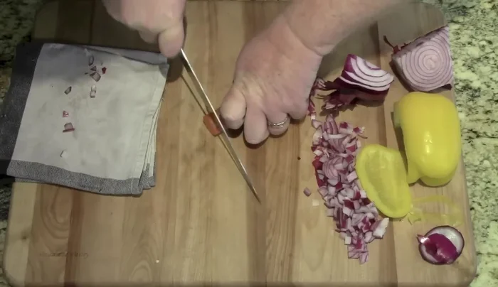 Sharp knife slicing vegetables.