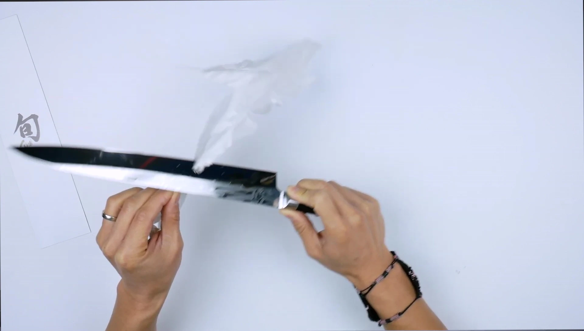 Razor-sharp knife effortlessly slicing paper.