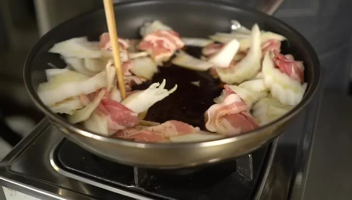 Add the tofu to the center of the pan, creating space for it without overlapping.