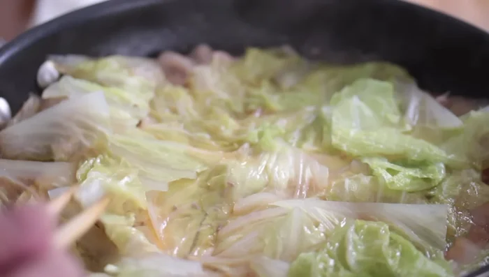 After 8 minutes, gently flip the cabbage leaves to ensure even cooking.